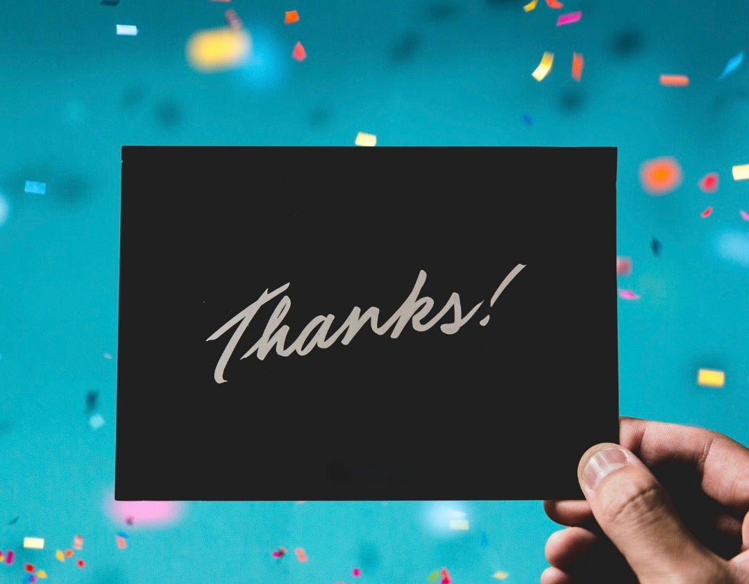 Teacher holding an Amazon gift card